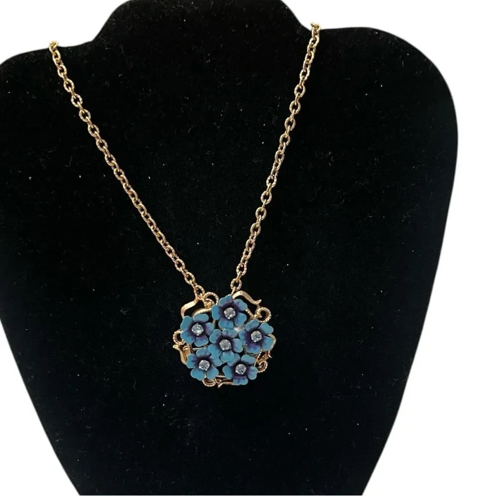 Vintage Avon blue flower pendant or broach on a gold colored chain EVC